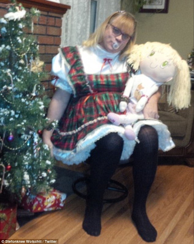 Christmastime: Stefonknee can be seen cuddling a doll and sucks on a pacifier near a Christmas tree