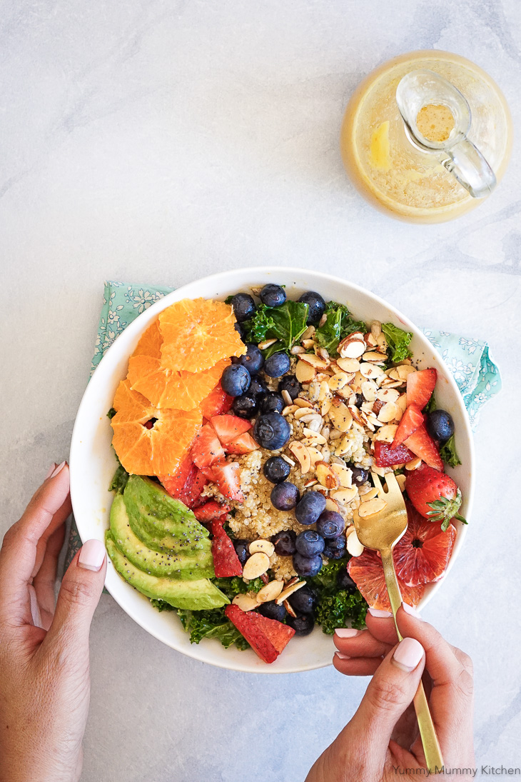 A beautiful healthy salad with kale, quinoa, berries, avocado and an easy orange vinaigrette dressing made in the blender.